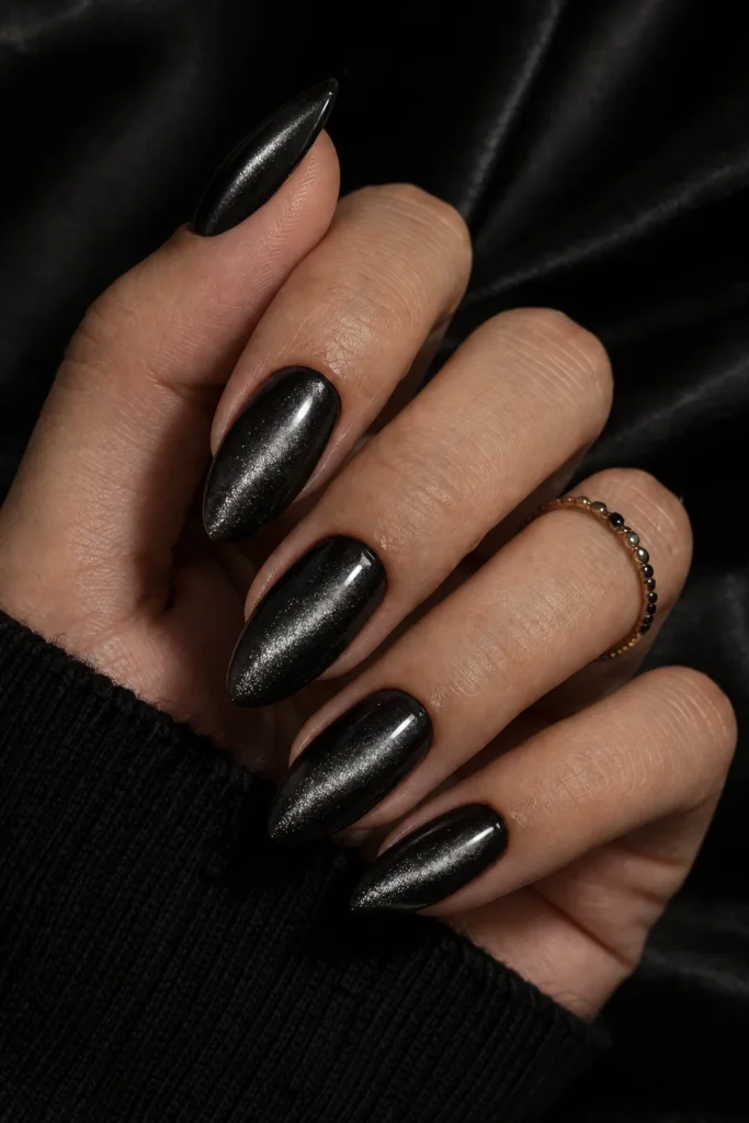 Black cat eye nails with a bright silver magnetic beam