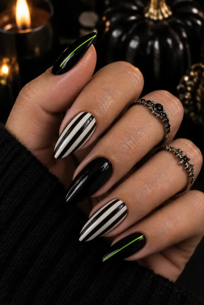 Long almond nails with black and white Halloween stripes
