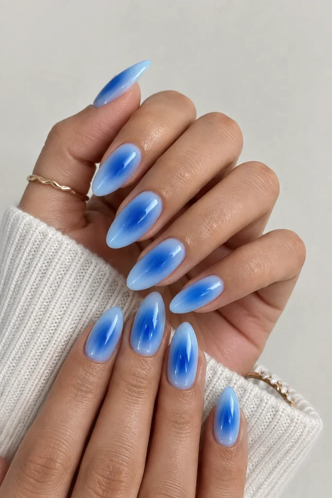 Blue aura nails with a pale blue base and deep cobalt center