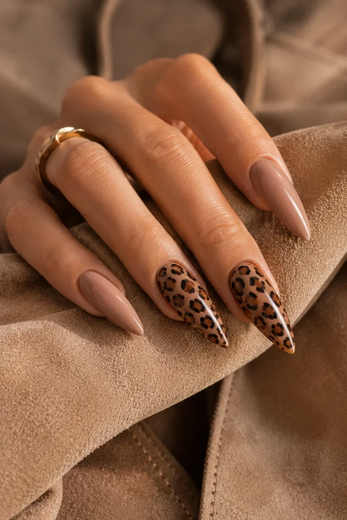 Long nude stiletto nails with detailed leopard-print accent nails