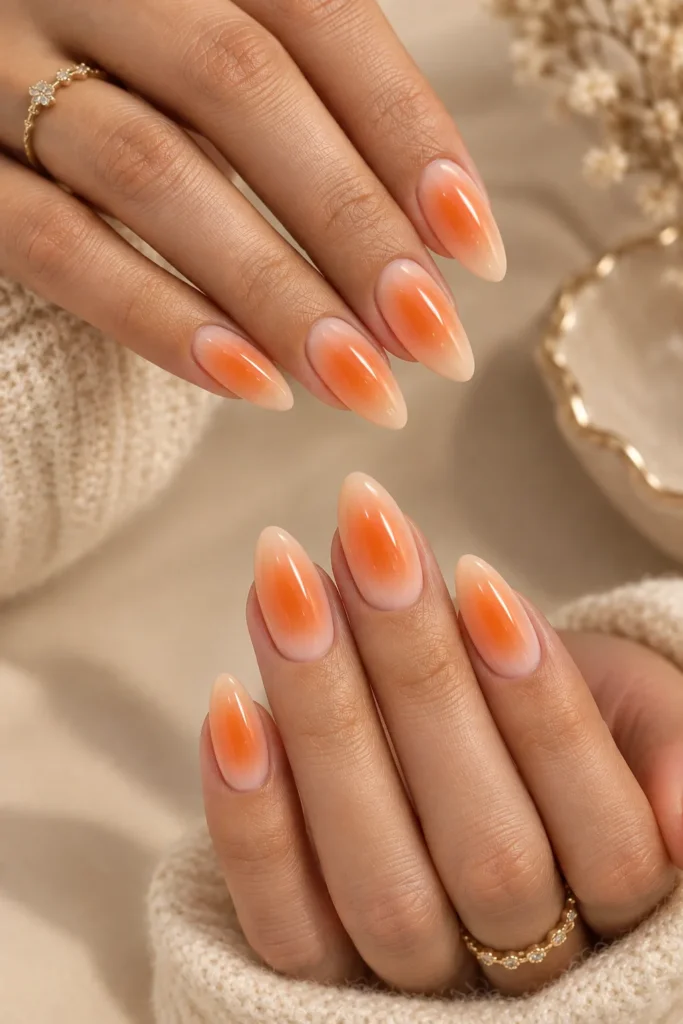 Peach and tangerine gradient manicure with a bright center