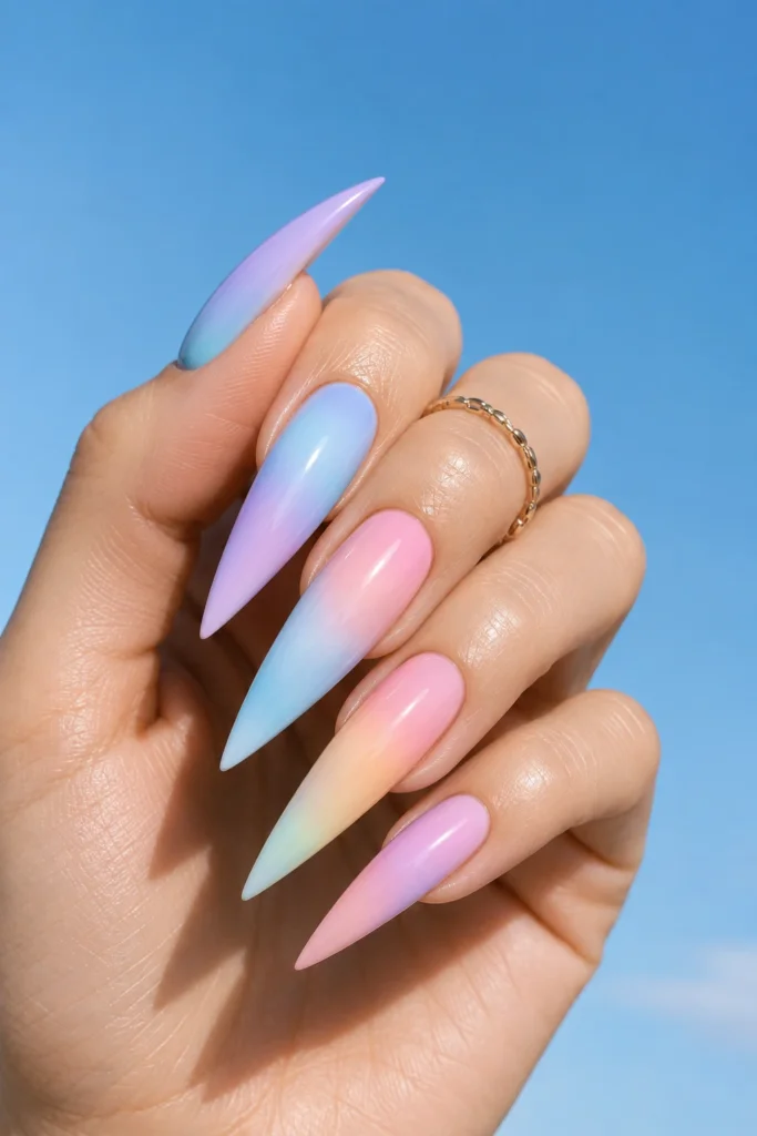 Long stiletto nails with a seamless pastel lavender and pink ombré gradient