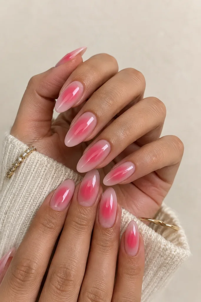 Pink aura nails on medium almond-shaped nails with a soft rosy center