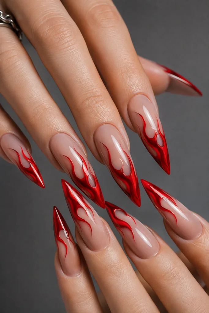 Red flame stiletto nail idea over a sheer nude base