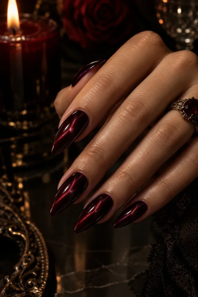 Black cherry cat-eye almond nails with glowing finish