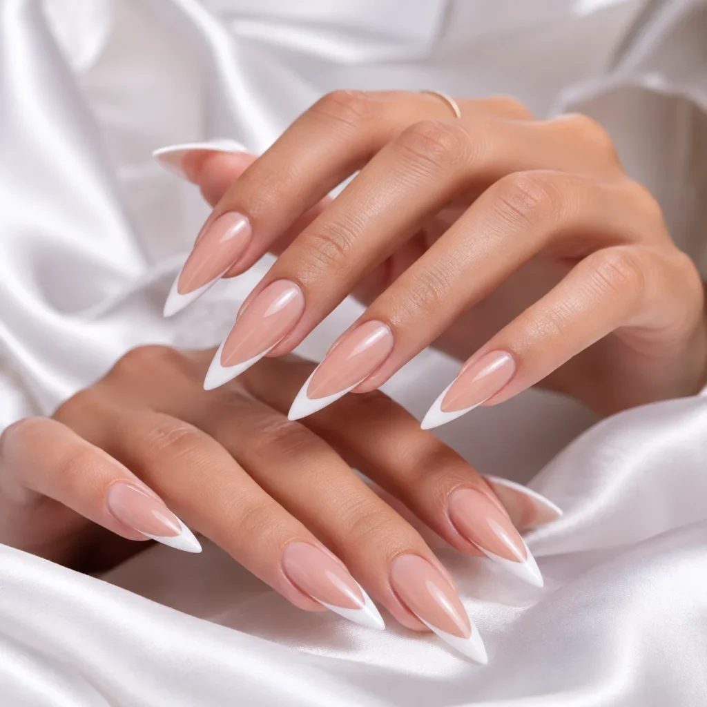 Long stiletto nails with a blush-pink base and crisp white French tips