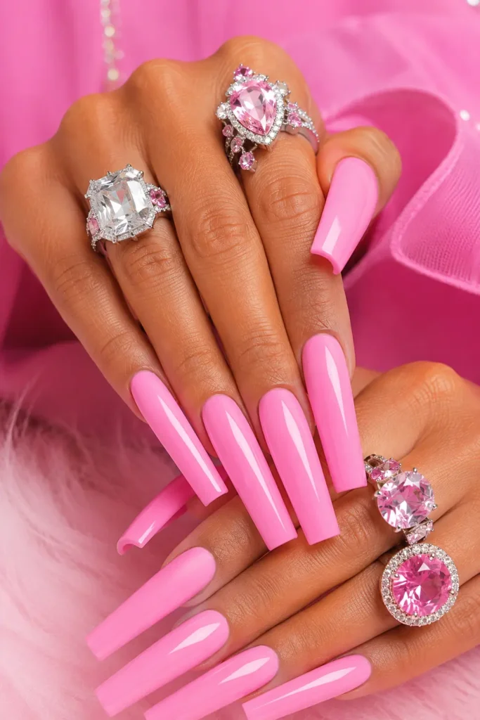 Extra-long Dolly Parton nails in a glossy Barbie pink finish