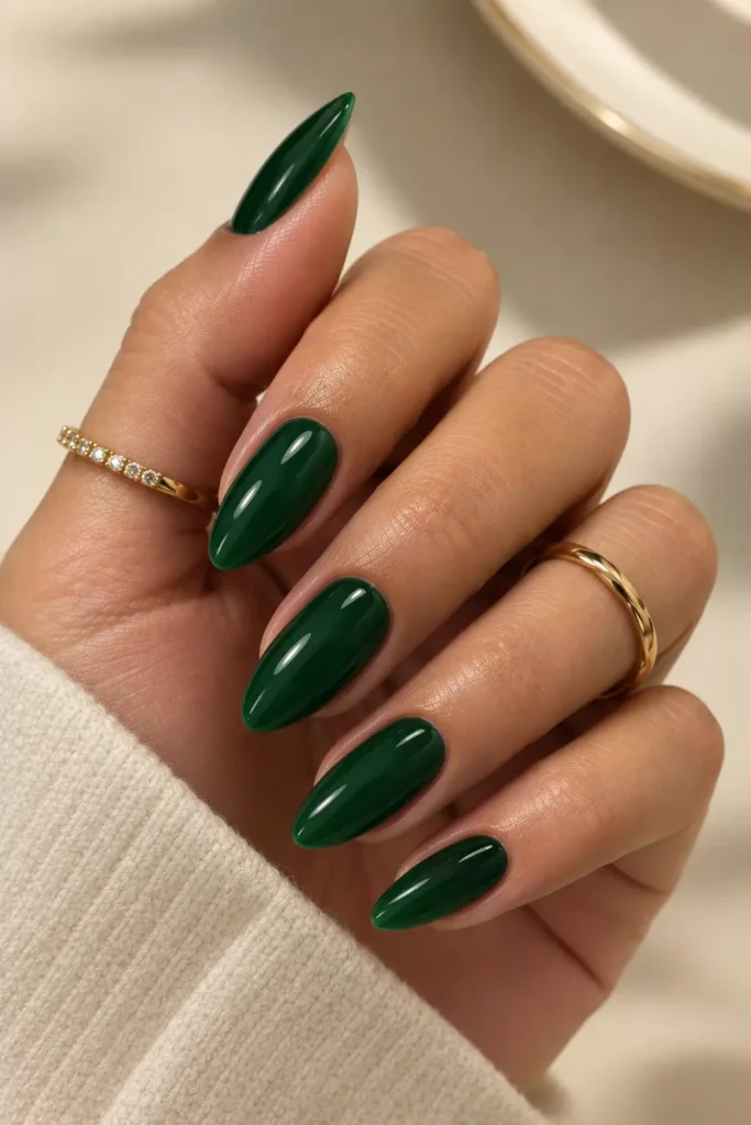 Glossy deep emerald green almond-shaped nails