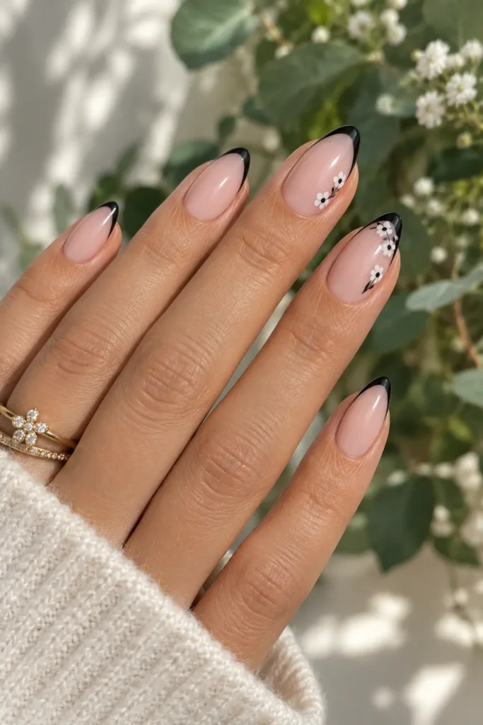 Black French tips with delicate white floral accents