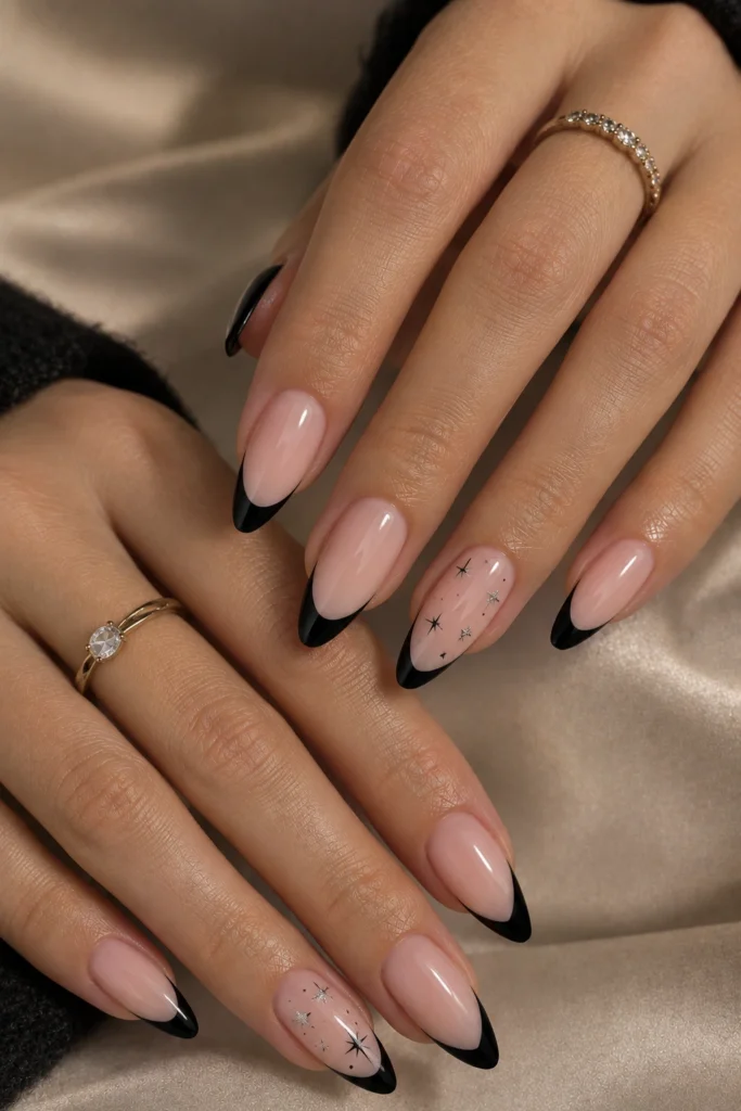 Black French tips with tiny celestial star accents