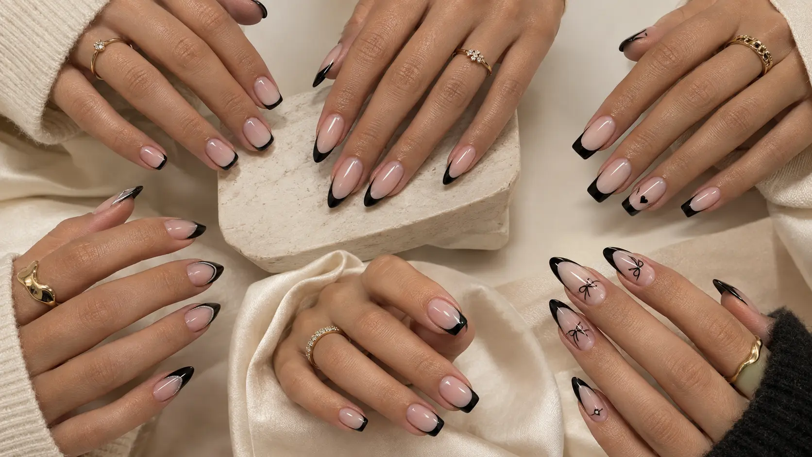 Classic black French tip nails on almond-shaped nails