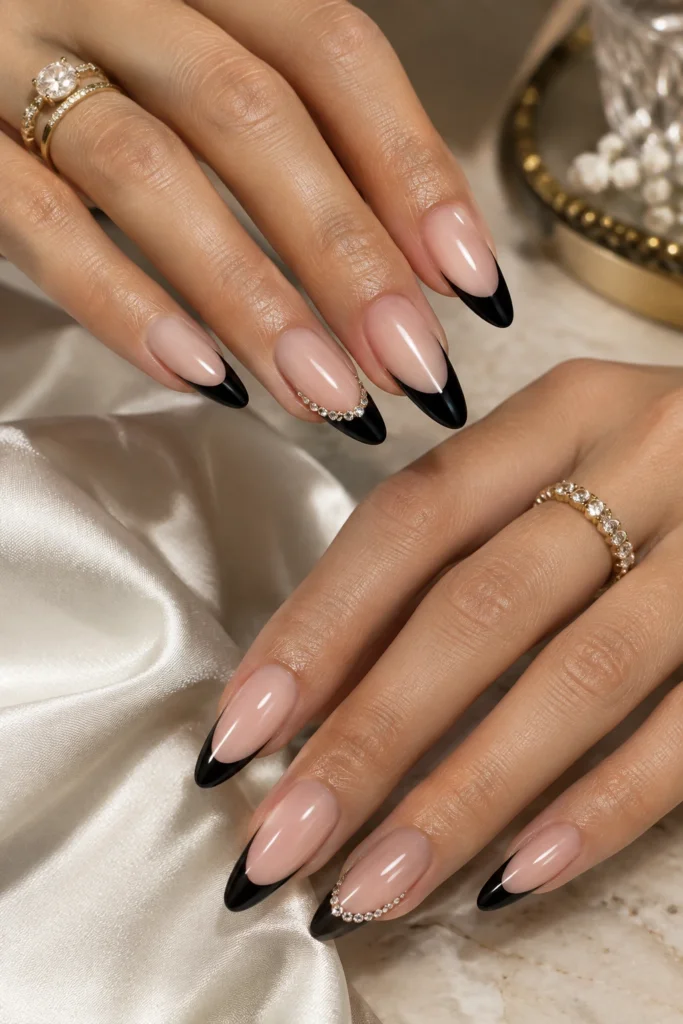 Black French tips decorated with delicate rhinestones