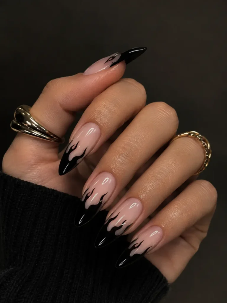 Glossy black French tips with flame-shaped designs