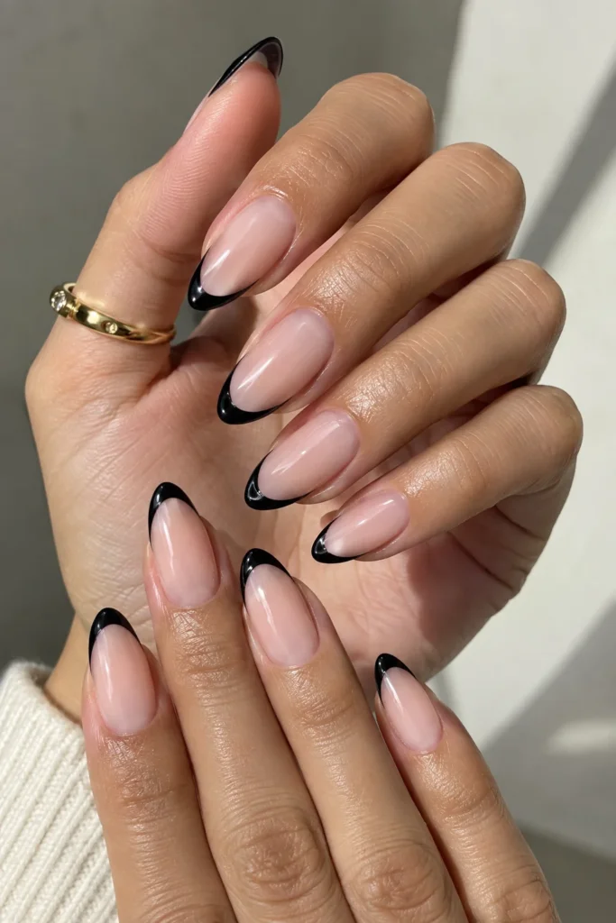 Almond nails with glossy curved black French tips