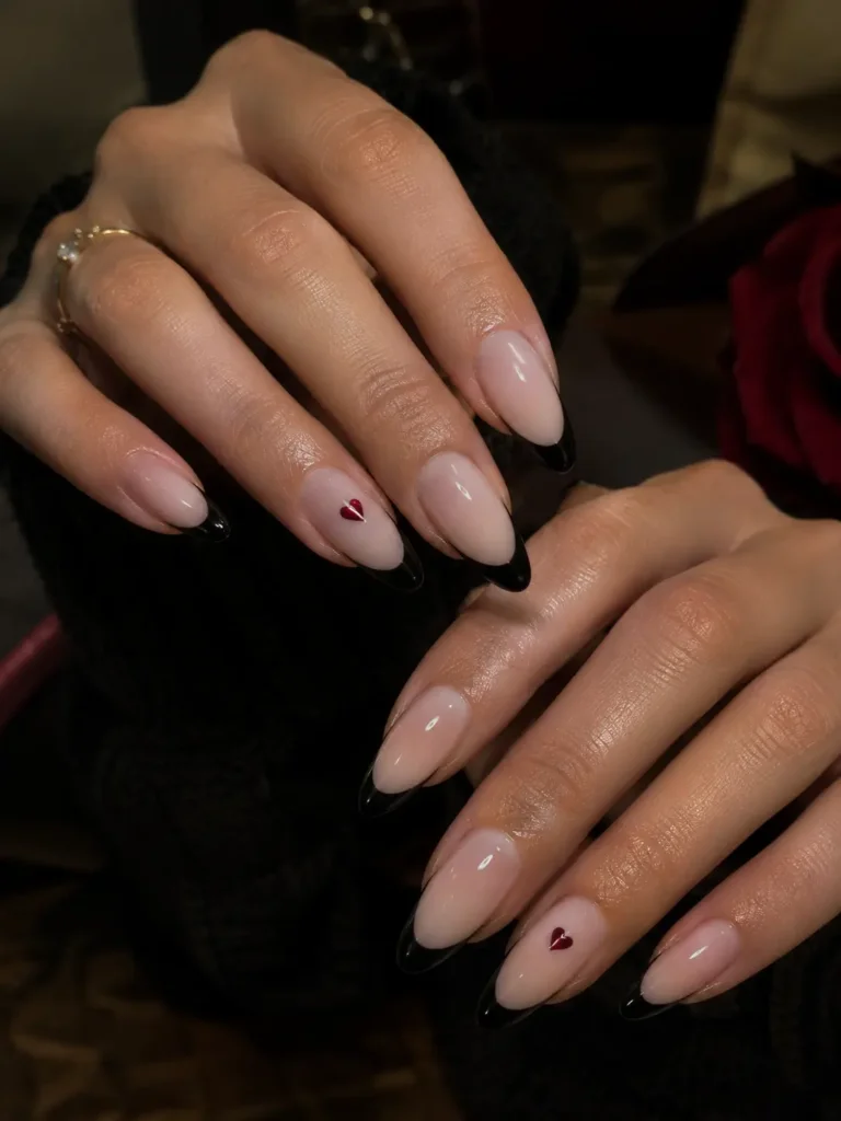 Black French tips with a tiny heart accent