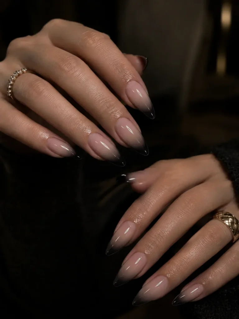 Long almond nails with a nude-to-black ombre finish