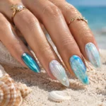 Iridescent turquoise and pearl mermaid nail ideas with chrome and seashell details