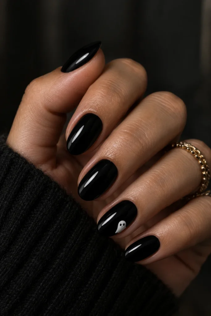 Easy Halloween nails with one white ghost on glossy black nails