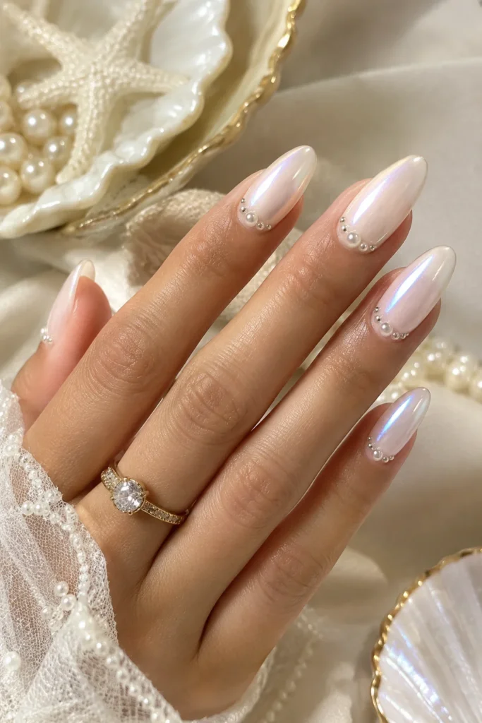 Pearl embellished manicure with chrome and delicate ocean-inspired details
