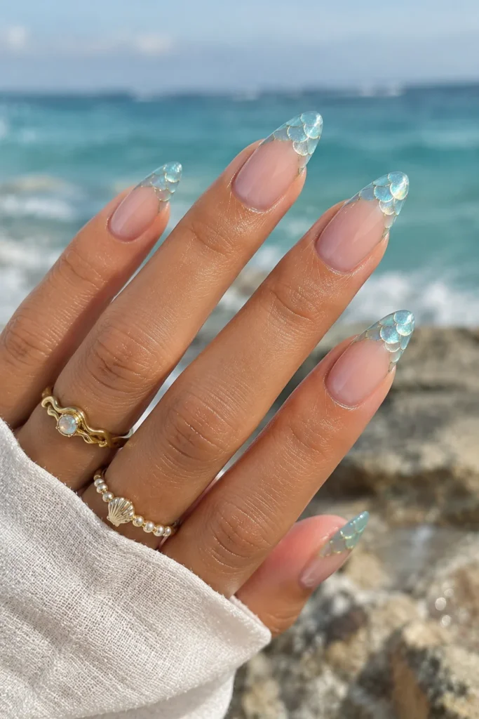 Aqua French tip manicure with delicate mermaid scale patterns