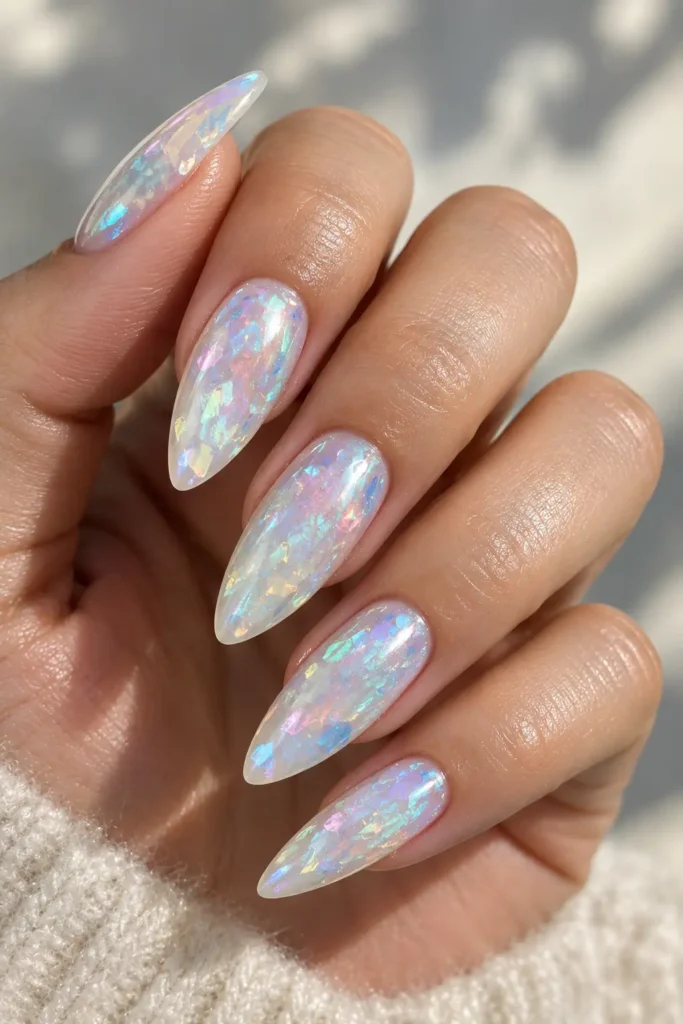 Opal manicure with soft pink, blue, lavender, and green reflections