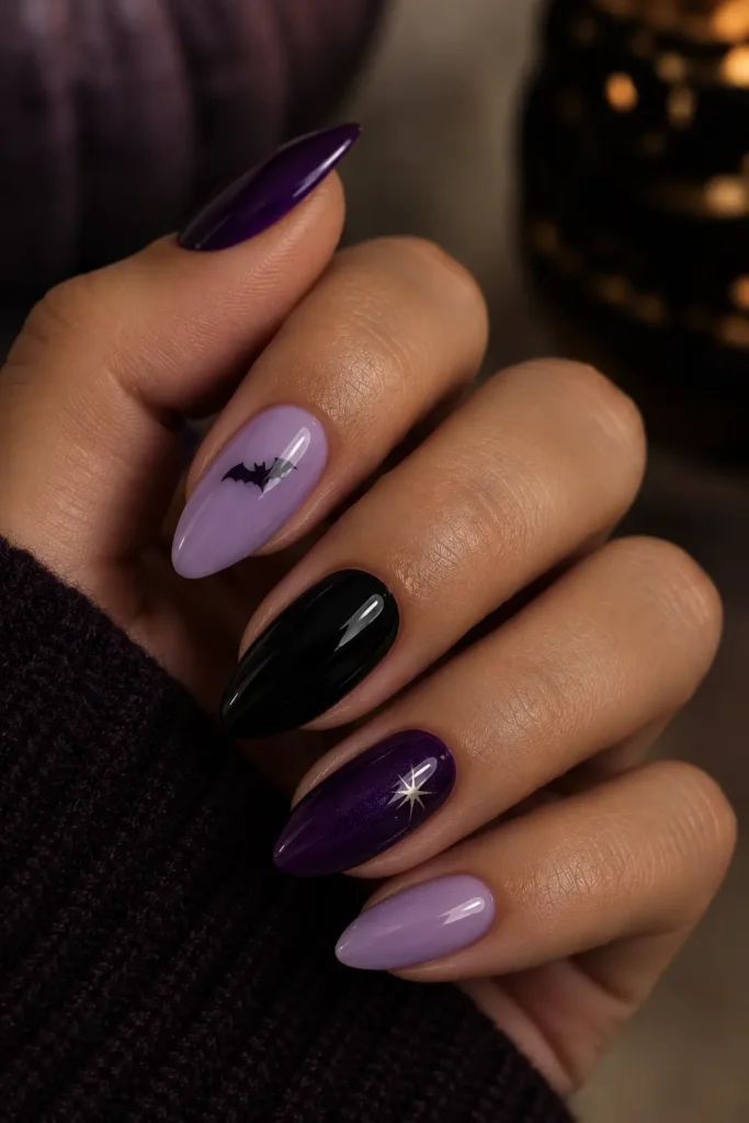 Purple, lilac, and black almond nails