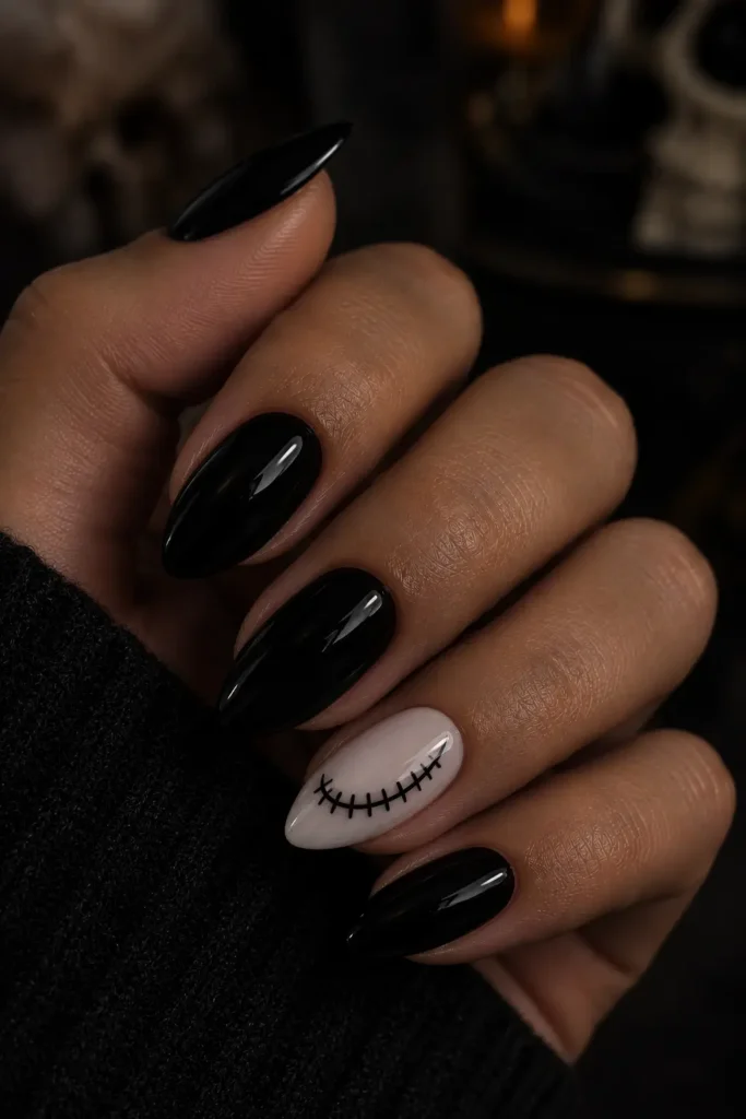 Black nails with a white skeleton smile accent